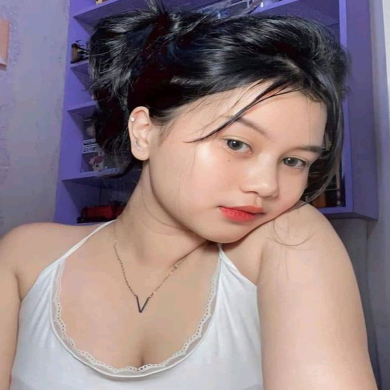 A lively casino scene featuring a row of bright, colorful slot machines with themes like Monopoly, Michael Jackson, and Lord of the Rings. The gaming machines display a variety of flashing lights and digital screens, creating an energetic and exciting atmosphere. Reflections of the lights are visible in glossy surfaces above the machines.